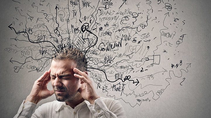 A person holding their head, surrounded by a tangle of scribbled arrows and words
